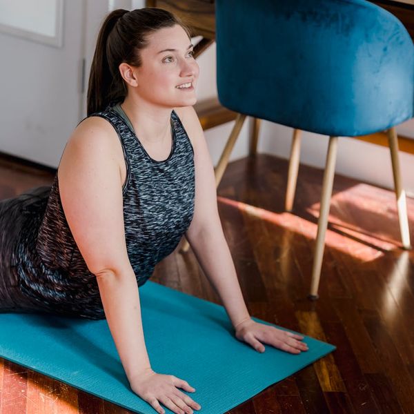 Person stretching gently in a bright, calm room.